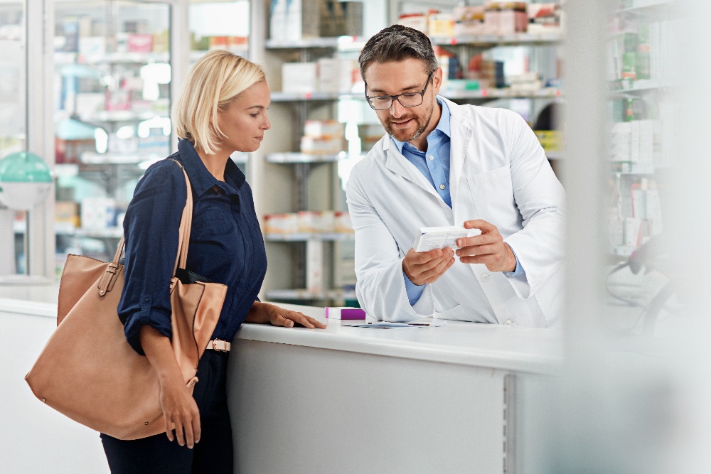 pharmacist explaining medication interaction to client